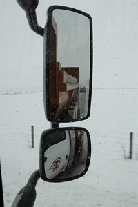 A car is seen in a side view mirror of an Elkhart County snowplow driven by Jerry Hann Tuesday, January 5, 2010. The nearly continual snowfall this week has been keeping plow drivers busy working to maintain the county roads. Truth Photo By Jennifer Shephard
