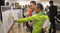 Mark Diaz and Ezekiel Flannery, Gary residents, check out maps of the proposed rail lines during a public hearing on NICTD plan to build a double-track system at the Marshall Gardner Center for the Arts, 540 N. Lake St., in Gary, IN., on Oct. 4, 2016. Staff photo by Mark Davis