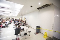 Heavy rains in August leaked through Mishawaka High School's roof and into the cafeteria, where a trash can collected drips. Officials hope to fix the roof if voter pass a referendum providing more tax revenue. Staff photo by Santiago Flores