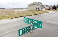 As depicted in this photo of a residential neighborhood cropping up in an agricultural area near Lapel in Madison County, urbans and suburban sprawl and other land uses have diminished acreage for agriculture in Indiana. Staff photo by John P. Cleary