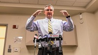 Indiana Gov. Eric Holcomb talks with the media following his round-table meeting with community leaders in East Chicago on Friday. Staff photo by Jim Karczewski