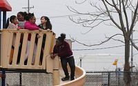 Children play on a slide during recess on Wednesday, Feb. 22, 2017, at East Chicago Urban Enterprise Academy. Across the street is the intersection of Chicago and Parrish avenues, the most northeast corner of the USS Lead Superfund Site. Staff photo by Kale Wilk