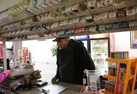 Ray Payne of Chicago buys cigarettes Thursday at Sam's Smoke Shop in Whiting. Indiana could raised cigarette taxes by $1 per pack under legislation being considered by the General Assembly. Staff photo by Jonathan Miano