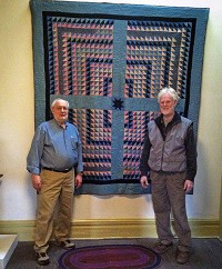 Ervin Beck, left, professor emeritus and member of the Mennonite-Amish Museum Committee and David Pottinger are pictured with a donated quilt. Photo provided