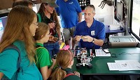 In this 2016 file photo, ETHOS Science Center robotics instructor Scott Chase discusses the subject with families at the Elkhart County 4-H Fair.