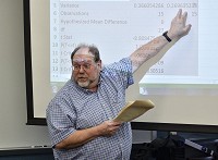 Rose-Hulman Institute of Technology professor Dale Bremmer goes over the numbers related to the proposed health care law with his students during a class on Thursday. Staff photo by Austen Leake