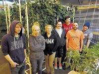 Devilan McKean, left, Alyson McDowell, Breanna Wheaton, Brandy Woodard, Caleb Keen, teacher Zac Martin and Kyle Fleming stand in one of the greenhouses at The Crossing School of Business and Entrepreneurship&rsquo;s flagship aquaculture school in Hamilton. PHOTO BY AMY OBERLIN