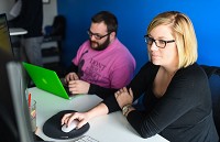SmartBox employees Keri Langer, right, and Gary WIlson work to complete a job for a client at the web marketing firm in New Albany on Tuesday, March 21, 2017. Staff photo by Tyler Stewart