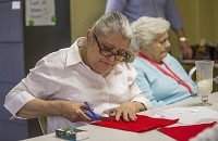 Diana Hunt works on crafts during a group activity in the River View 500 apartment building in Mishawaka where she lives in assisted living. Staff photo by Robert Franklin