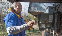 Rick Barrow, a technician with Smithville Fiber, installs a fiber connection at a home in Elletsville. Staff photo by David Snodgress