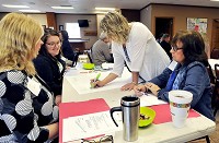 From left, Kim Vermillion of Jane Pauley Health Center, Heather Morrow of Kleenco, Andrea Stafford and Missy Abernathy,&nbsp; both from Alexandia Community Schools, work in small groups doing an exercise on student skills mapping. It was part of a meeting Monday as representatives from the community and&nbsp; Alexandria schools worked on&nbsp; plan to apply for a grant from Lilly Endowment. Staff photo by John P. Cleary