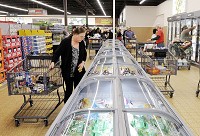 Customer Darlene Deck looks in the freezer section as ALDI opened its remodeled Anderson store on Thursday. Staff photo by Don Knight
