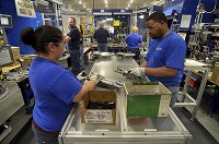 Jessica Blankenship and Steve Potter, employees at Thyssenkrupp Presta North America, assemble componets in the manual column assembly line at the plant in the Vigo County Industrial Park. Staff photo by Joseph C. Garza