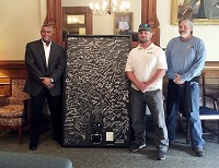 A solar panel signed by 350 Hoosiers was presented to Gov. Eric Holcomb's office on Monday in hopes of getting him to veto a bill that opponents sa would limit future expansion of solar energy in Indiana. From left are Reggie Henderson of Telamon Corp. and Phil Teague and Dale Dashiell of Rectify Solar. Submitted photo