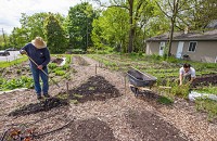 Jelena Farms owner Nick Licina, left, and farm manager Richie Janssen, work on one of their gardens on a lot where the city demolished a home in the 400 block of Corby Boulevard in South Bend. Staff photo by Robert Franklin
