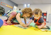 A new daycare, Honey Bees, is set to open at Anderson Wesleyan Church. Jesa Alexander, 2, and Carter Overdord, 1, play with a puzzle at the church's facility. Staff photo by John P. Cleary.