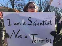 Mahsa Najafzadeh, a postdoctoral student in computer science at Purdue University, who is from Iran, held up a sign that read, "I am a Scientist, Not a Terrorist," at a peaceful protest against the immigration ban held in the Memorial Mall at Purdue on Thursday, Feb. 2, 2017. Staff photo: Meghan Holden/Journal &amp; Courier)