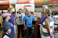 Jay and Nancy Ricker, right, co-founders of Ricker's convenience stores, chat with Libertarians who organized a Drink In for Liberty at the Ricker's store in Columbus. The event show support for the chain and for reforming Indiana alcohol laws. CNHI Statehouse Bureau photo by Scott Miley