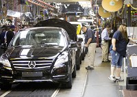 Workers stand next to the Mercedes-Benz R-Class production line at AM General's Commercial Assembly&nbsp; Plant in Mishawaka in this 2015 file photo. Staff photo by Becky Malewitz