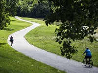 Walkers and bikers travel along the White River Greenway Tuesday morning. Staff photo by Jordan Kartholl