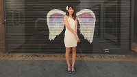A woman poses with angel wings painted on a wall in Los Angeles. Crown Point Councilwoman Carol Drasga hopes to do a similar project in the downtown square. Provided photo