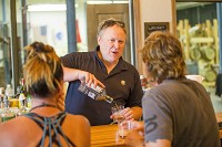 Owner Charles Florance pours a drink while talking with Terry Olson and Shaina Burkett at The Indiana Whiskey Co. on Sample St. in South Bend on Tuesday. Staff photo by Michael Caterina