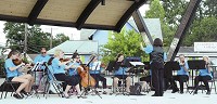 Director Kim Randinelli leads the Auburn Community Orchestra in a recent performance at the James Cultural Plaza in downtown Auburn. The orchestra will return to the plaza for a concert Aug. 19.
