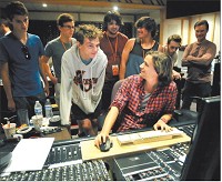 Student Noah McCullough, 18, front left, talks with producer Stephen Potaczek as he plays back the mastered version of Noah&rsquo;s song he recorded Thursday at Gaither Studios. McCullough is a senior at Perry Meridian High School in Indianapolis. Staff photo by John P. Cleary