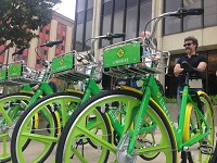 Freshly delivered LimeBike bicycles await customers Tuesday in downtown South Bend. Tribune Photo/JOSEPH DITS