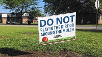 Signs put up by the EPA warn residents in the West Calumet Housing Development not to play in the dirt or mulch. (Joe Puchek / Post-Tribune)