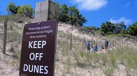 New paths and warning signs guide visitors up and down Mount Baldy inside Indiana Dunes National Lakeshore. The beach has recently reopened after being closed for several years. (Michael Gard / Post-Tribune)
