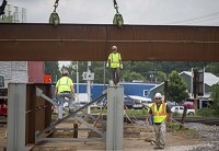 Construction crews work on a railroad overpass for the U.S. 33 realignment project in Goshen last week. Tribune Photo/ROBERT FRANKLIN
