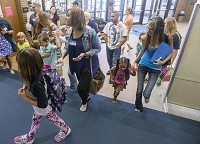 Meadow&rsquo;s Edge Elementary kindergarten students and their parents attend the first day of school in Mishawaka in August 2015. Some local school corporations have increased efforts during the summer to retain students before school starts. Staff file photo by Becky Malewitz