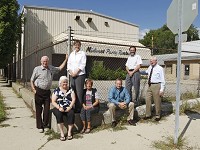 In this 2011 photo, Centennial neighborhood residents Bill Uerkwitz, from left, Brenda Canaan, Barbara Dixon, KJ Nutt, Bill Bray, Steve Belter and Michael Hunt posed outside the former Midwest Rentals and Fifth and Brown streets after they'd chipped in about $127,000 to help buy and redevelop the property in their neighborhood. Journal and Courier file photo