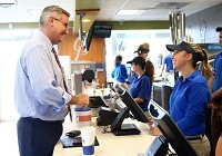 Gov. Eric Holcomb orders a chocolate shake from Faith Renken, right, at Cone Palace during his visit to Kokomo on Tuesday, Aug. 1, 2017. Staff photo by Kelly Lafferty Gerber | Kokomo Tribune