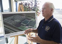 Darryl Searer talks about the RV/MH Hall of Fame expansion plant in front of a rendering of it in this Aug. 10, 2016 file photo. Staff photo by Sam Householder
