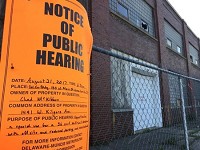 A notice of public hearing is posted outside the former Muncie Trade School. Staff photo: Seth Slabaugh/The Star Press
