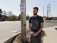 Purdue University freshman Brandon Wolter waits at a bus stop outside Blackbird Farms Apartments on Wednesday, Aug. 23, 2017. Wolter is one of 240 students who were placed in Blackbird apartments due to overflow in on-campus residential halls. Staff photo: Meghan Holden/Journal &amp; Courier