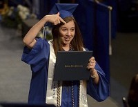Look at this: An ISU graduate points to her diploma after she accepted it May 13 during the spring commencement. Tribune-Star file/Joseph C. Garza