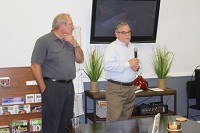 Craig Fenneman, left, and Doug Molin speak during Tuesday's community conversation about the project taking place in downtown Martinsville. Staff photo by Lance Gideon