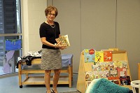 Child and Parent Services President and CEO Candy Yoder looks at a children's book in the preschool room located in the new CAPS Joy Royce Center in Elkhart. Staff photo by Sherry Van Arsdall