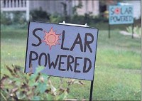 Colorful signs identify solar-powered homes Tuesday on South Washington Street in Bloomington. Staff photo by Chris Howell