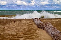 Waves break near driftwood at scenic Kemil Beach, which is part of the Indiana Dunes National Lakeshore. A U.S. House committee on Wednesday unanimously agreed the National Lakeshore should become a national park. It goes now to the full House for a vote. Staff file photo by Marc Chase