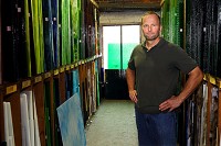New owner Jeff Shaw stands Wednesday at Kokomo Opalescent Glass, which he purchased last month. Staff photo by Tim Bath