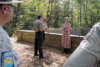 Lieutenant Governor Suzanne Crouch spoke with Lincoln Boyhood National Memorial Chief of Interpretation Mike Capps, left, and Lincoln State Park naturalist Michael Crews on Friday near the land where the 16th President's home was built. Staff photo by Allen Laman