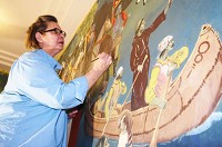 Mary Yeager of Acanthus Arts touches up one of the Fountain County Courthouse murals. Acanthus Arts has spent the past months restoring and preserving the work, which was painted by Covington native Eugene F. Savage in 1937-39. Staff photo by Nick Hedrick