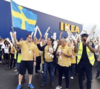 Employees at the new Ikea store in Fishers cheer as customers wait for the doors to open Wednesday morning. Staff photo by Andy Knight