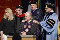 WELCOME HOME:&nbsp;Taylor University President Paul Lowell Haines, kneeling, is joined by, from left, his wife, Sherry, and former Taylor presidents Jay Kesler, David J. Gyertson and Eugene B. Habecker for a laying of hands during Haines&rsquo; inauguration on Friday. Staff photo by Jeff Morehead