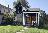 This vacant house damaged by fire at 1825 Fletcher St. is scheduled for demolition, which would remove an eyesore, according to area residents. Staff photo by John P. Cleary