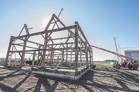 The skeleton of a 165-year-old barn on East 700 South in Cass County is being dismantled to be shipped and reassembled in Australia. The new owner plans to make it into a home. Staff photo by Fran Ruchalski